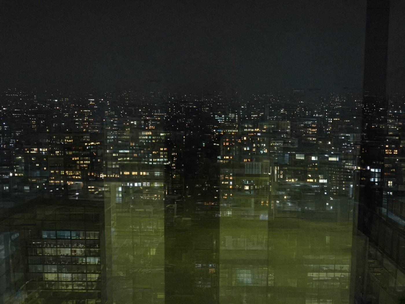 Night city grid of windows read as clustered audience points.